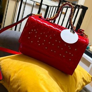 Big red purse with gold chain design. Brand new never worn